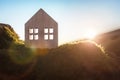 Ecological wood  model house in empty field at sunset Royalty Free Stock Photo