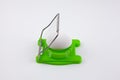 Green egg cutter with a boiled egg Royalty Free Stock Photo