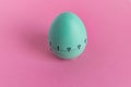 Green egg timer on pink background. Happy Easter in the kitchen. Home related, home staying. Free copy space. Flat lay, top view Royalty Free Stock Photo