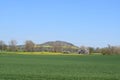 green Eifel village with blooming trees and fields at a volcano