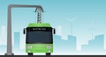 Green electric bus at a stop is charged by pantograph