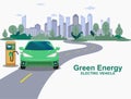 Green Electric car on the charging station, city full of trees street Royalty Free Stock Photo