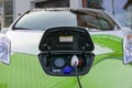 Green electric car charging on the street Royalty Free Stock Photo