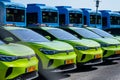 Green electric Volkswagen cars parked in a row..