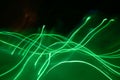 Green electricity wave like light streaks on black background