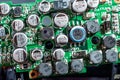Green electronic board with many capacitors and resistors close-up. Electronic camera chip