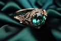 Green Emerald Fashion Engagement Diamond Ring on Green Satin Background.