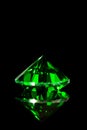 Green emerald in front of black background, flawless gem Royalty Free Stock Photo