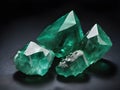 Green Emerald gemstone with rough cut or uncut. Dark studio background Royalty Free Stock Photo