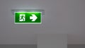 Emergency exit sign on ceiling inside of building Royalty Free Stock Photo