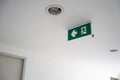 Green emergency exit sign. Direction to the escape way on white Royalty Free Stock Photo