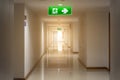 TheÃ¢â¬â¹ green emergency exit sign in hotel showing the way to escape