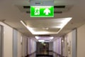 Green emergency exit sign showing the way to escape.Fire exit in the building Royalty Free Stock Photo