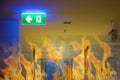 Green emergency exit sign showing the way to escape.Fire exit in the building. Royalty Free Stock Photo