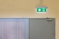 green emergency exit sign to install over the door building construction showing the way to escape