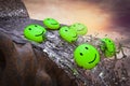 Green emojis fall from a waterfall at sunset magenta day demonstrating customer satisfaction rating failure concept. 3D.