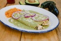 Green enchiladas mexican food with tomato sauce and cheese in mexico Royalty Free Stock Photo