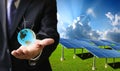 Green energy concept, Businessman carry world of wind turbine Royalty Free Stock Photo