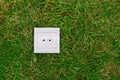 Green energy concept: electric outlet on a grass Royalty Free Stock Photo