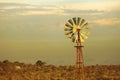 Green energy vintage wind mill sunset background Royalty Free Stock Photo