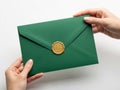 Green envelope with gold seal isolated on white background Royalty Free Stock Photo
