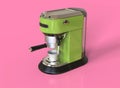 A green espresso coffee machine on pink background.