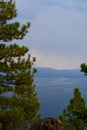 Evergreen Trees in Foreground of Lake and Mountains Royalty Free Stock Photo