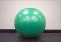 Green exercise ball on an isolated background at the gym