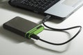 Green external hard disk with cable on white