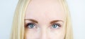 Green eyes of a beautiful girl. White background. Blonde freckles Royalty Free Stock Photo