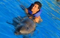 Green eyes man swimming with a gorgeous dolphin flipper smiling face happy kid swim bottle nose dolphins Royalty Free Stock Photo