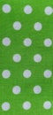 Green fabric with polka dots. White circles. Close-up. Fabric for sewing dresses and home furnishings. Banner