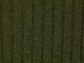 Green fabric sweater close up texture background