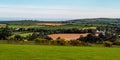 Green farm fields and hills in the evening in Ireland. Irish rural landscape, agricultural land. Green field near green trees Royalty Free Stock Photo