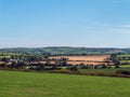 Green farm fields and hills in the evening in Ireland. Irish rural landscape, agricultural land. Green grass field near green Royalty Free Stock Photo