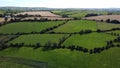 Green farm fields of Ireland lined with trees, top view. Green Irish landscape