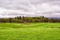 Green farm fields under a cloudy sky in Scotland, United Kingdom Royalty Free Stock Photo