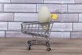 Green farm fresh egg in a tiny shopping cart Royalty Free Stock Photo