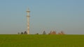 Farmland with radio tower of an airport in the flemish countryside