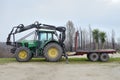 Green farm tractor with trailer