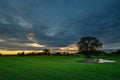 Green farmland and cloudy evening sky, Zarzecze, Poland Royalty Free Stock Photo