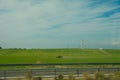 Green feilds and highway mooving cars veiw from side. The road along fields and forests