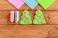Green felt Christmas tree ornament with pink and blue balls on a wooden background. Christmas tree felt embroidery Royalty Free Stock Photo
