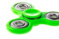 Green fidget spinner close up, stress relieving toy isolated on white background. Royalty Free Stock Photo
