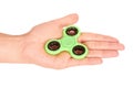 Green fidget spinner in hand isolated on white background Royalty Free Stock Photo
