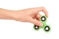 Green fidget spinner in hand isolated on white background Royalty Free Stock Photo