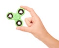 Green fidget spinner in hand isolated on white background Royalty Free Stock Photo