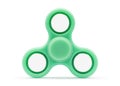 Green fidget spinner isolated on white background. Stress relieving toy