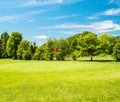 Green field and beautiful blue sky. golf course Royalty Free Stock Photo