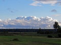Big white clouds over the field Royalty Free Stock Photo